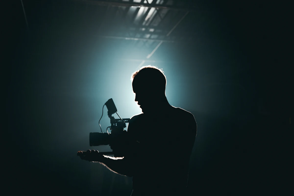 Silhouette of a camera operator holding a camera