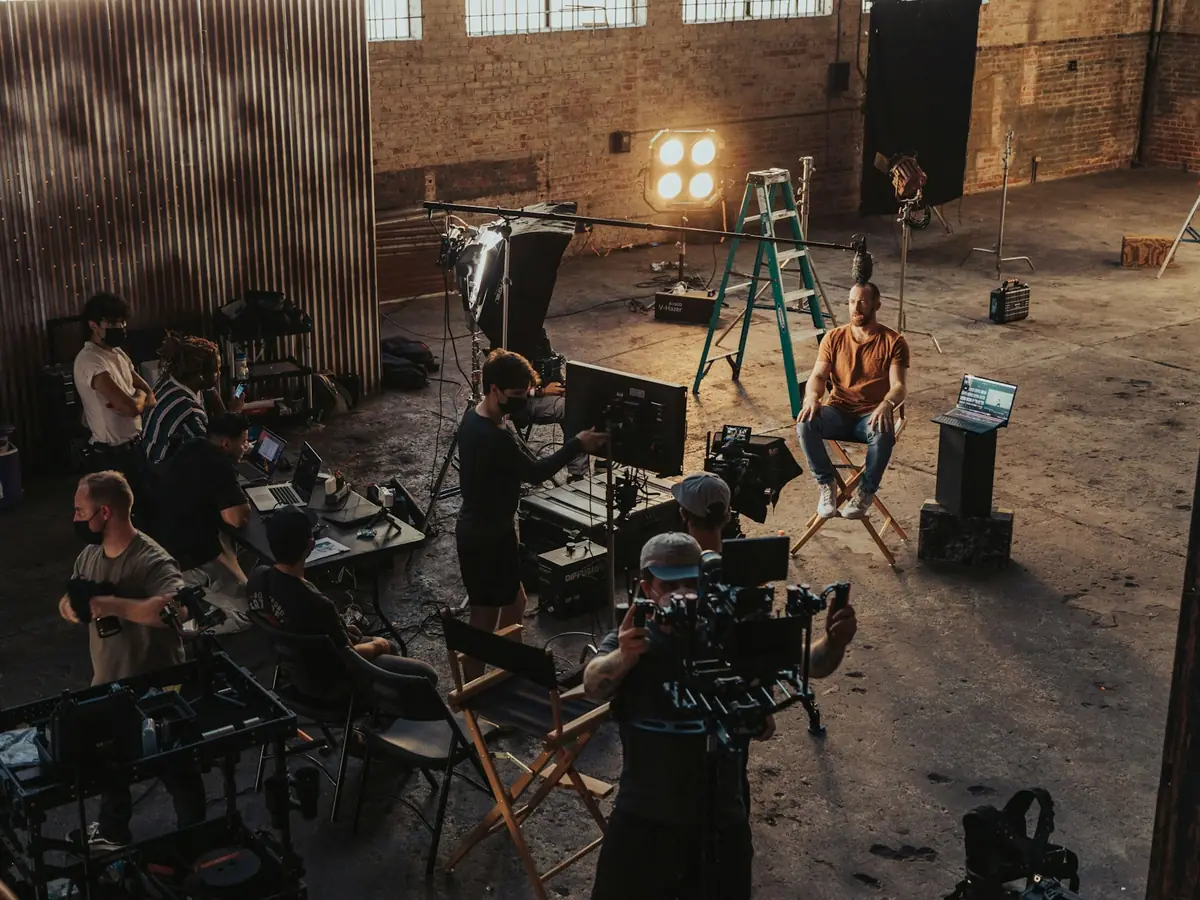 A film crew gathered around a cinema camera on set