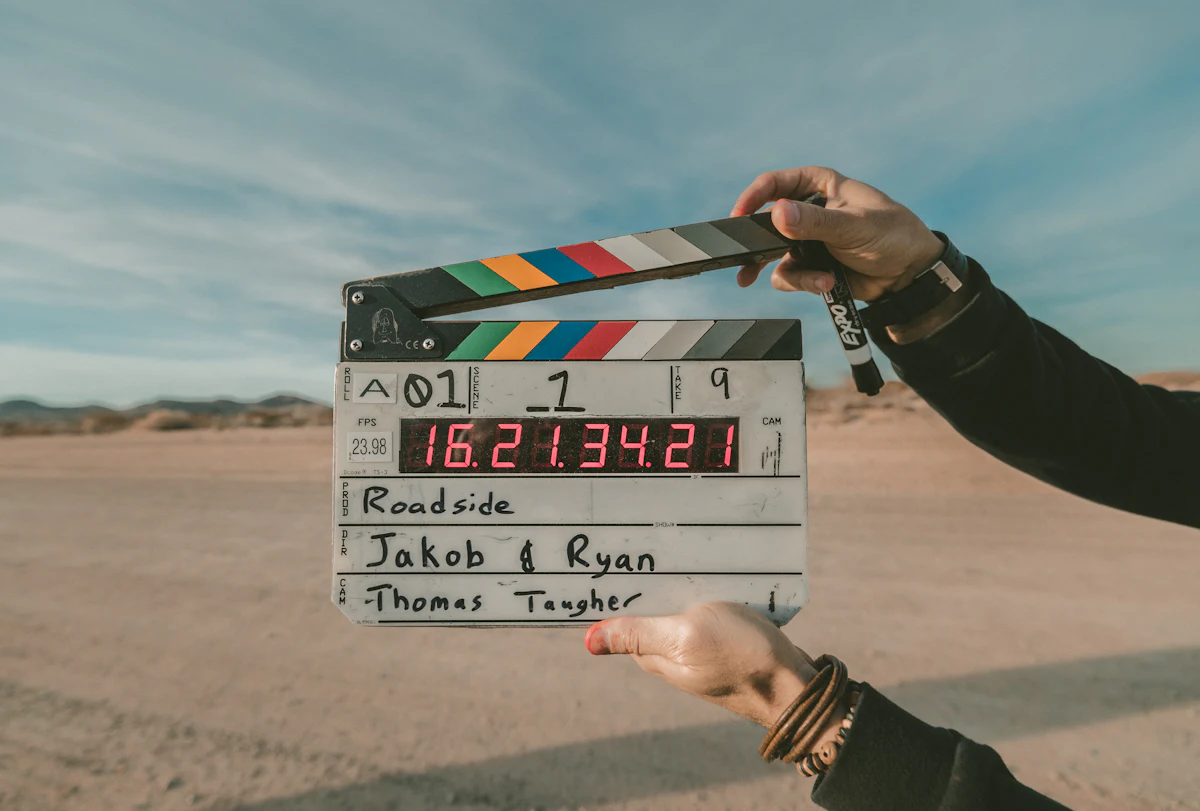 A clapperboard held up on a roadside shoot