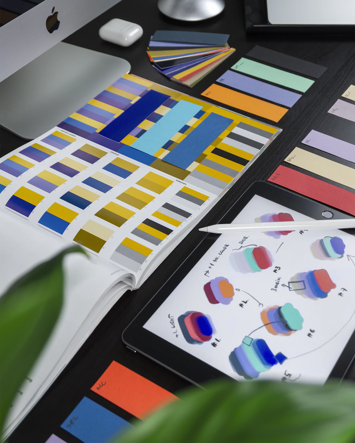 A colour code book opened to a spread of swatches