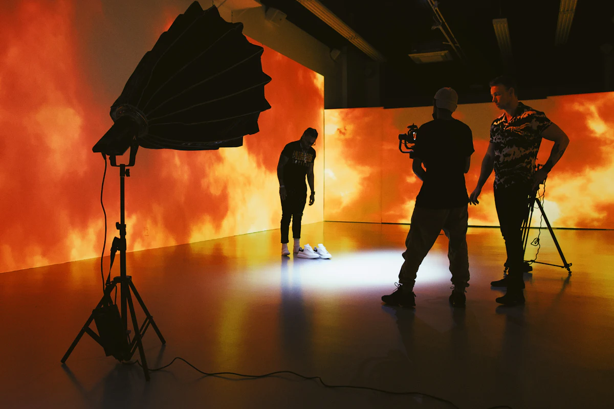Silhouettes of crew holding umbrellas on a night shoot